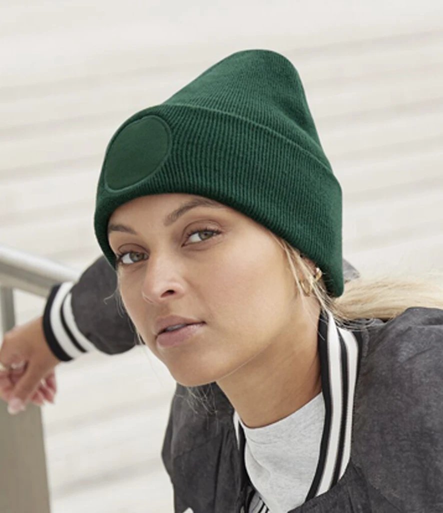 Model wearing a bottle green Beechfield Circular Patch Beanie