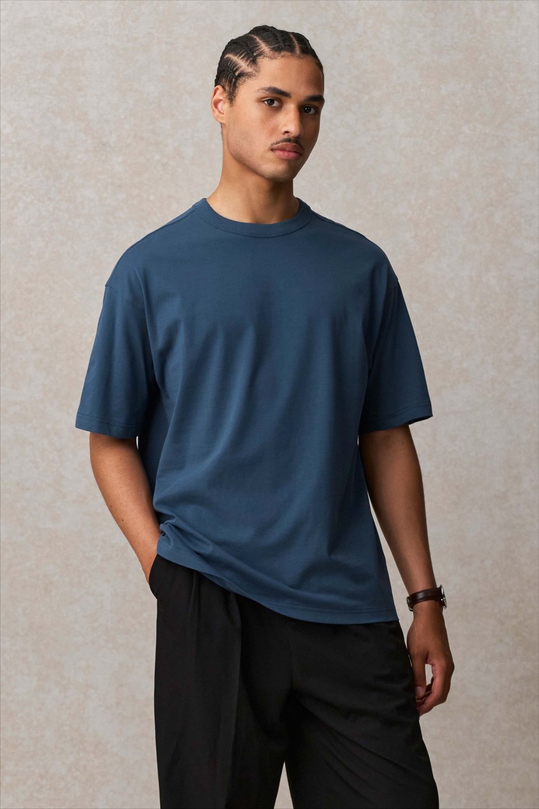 Model wearing a denim blue SOL'S Boxy oversized T-shirt, front view