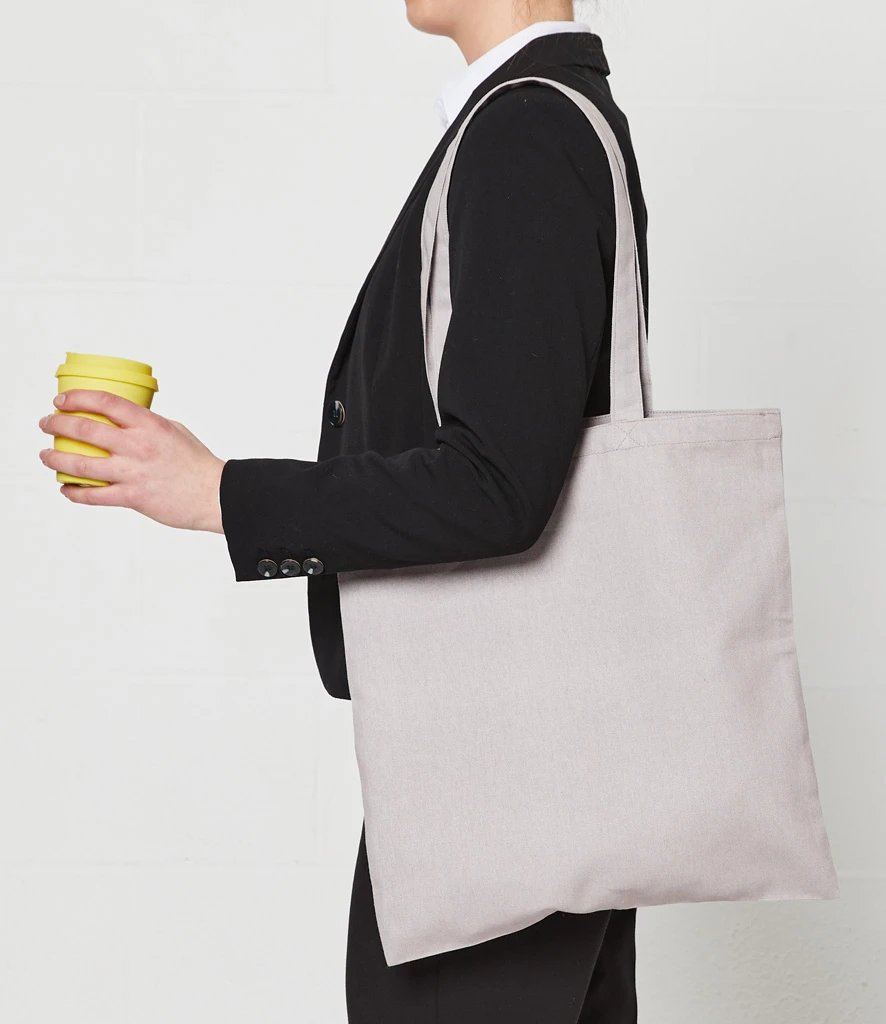 Model carrying a plain light grey Brand Lab cotton long handle shopper tote bag over the shoulder